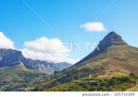 View of mountains with a path and cityscape against blue sky copyspace. A peaceful mountain with a scenic background in quiet Lions Head in Cape Town, South Africa. Nature backdrop with a hill top 105713384