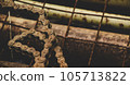 Scrap metal for recycling background. a lot of different rusty industrial part detail for melt and reused. Old rusty metal surface. Abstract background for design purpose. Warm orange color. Random 105713822