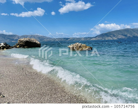 Rocky beach and crystal turquoise water of Ionian Sea in Albania. 105714756