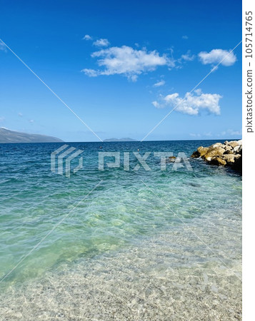 Rocky beach and crystal turquoise water of Ionian Sea in Albania. 105714765