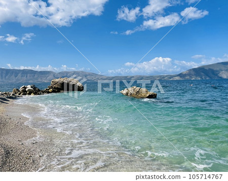 Rocky beach and crystal turquoise water of Ionian Sea in Albania. 105714767