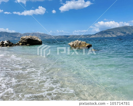 Rocky beach and crystal turquoise water of Ionian Sea in Albania. 105714781