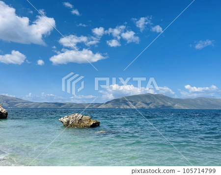 Rocky beach and crystal turquoise water of Ionian Sea in Albania. Rocky beach and crystal turquoise water of Ionian Sea in Albania. 105714799