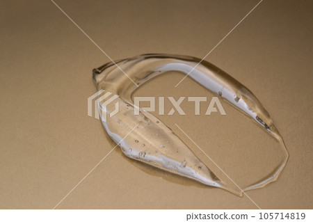 Transparent hyaluronic gel on a beige background. 105714819