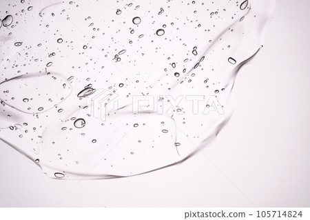 The texture of a thick cosmetic gel on a neutral background. The texture of a thick cosmetic gel on a neutral background. 105714824