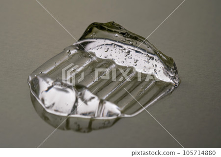 Transparent hyaluronic gel on a green background. 105714880
