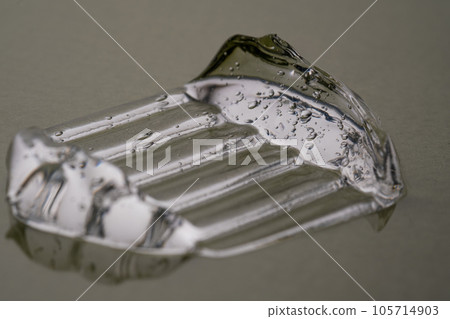 Transparent hyaluronic gel on a green background. 105714903