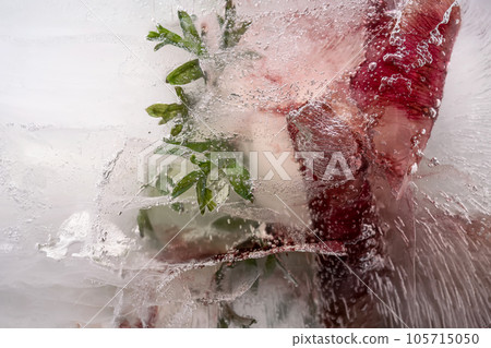 Transparent white ice with flowers frozen in it. Transparent white ice with flowers frozen in it. 105715050