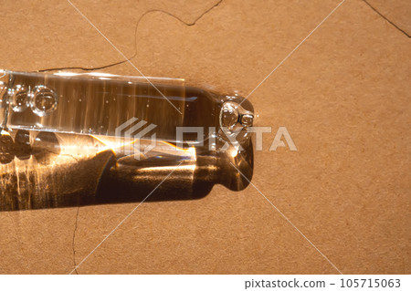 A pipette of cosmetic gel on a beige background. 105715063