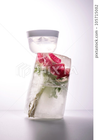 A jar of cosmetic gel on a background of ice with flowers. 105715082