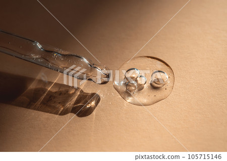 A pipette of cosmetic gel on a beige background. 105715146