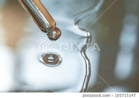 A pipette of cosmetic gel on a beige background. 105715147