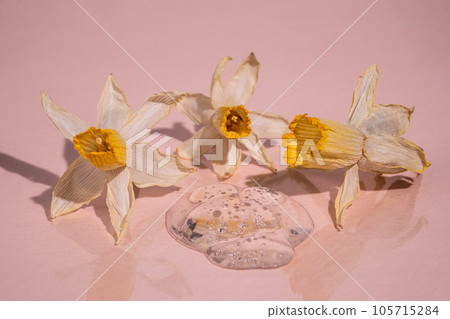 A dried narcissus flower above the serum. A dried narcissus flower above the serum. 105715284