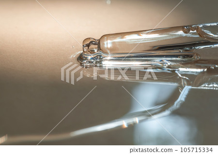 A pipette of cosmetic gel on a beige background. 105715334