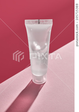 Transparent bottle of cosmetic gel on a pink background. 105715369