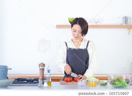 A woman who cooks in the kitchen A woman who cooks in the kitchen 105715607