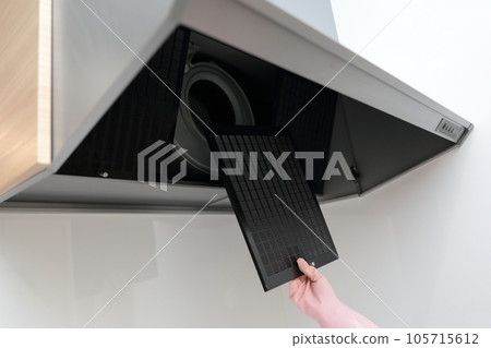 Woman's hand cleaning the range hood 105715612