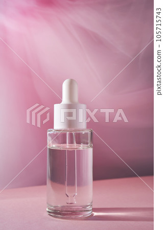 Transparent bottle of cosmetic gel on a pink background. 105715743