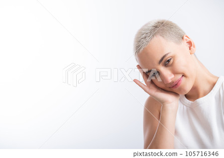 Pretty young woman with a short blond haircut on a white background. Pretty young woman with a short blond haircut on a white background. 105716346