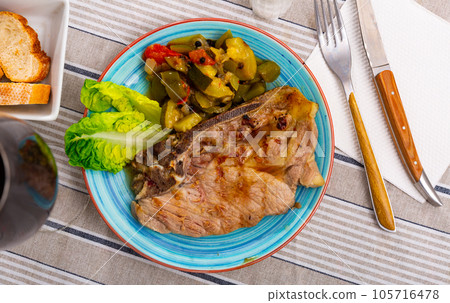 Pork steak with stewed vegetables 105716478