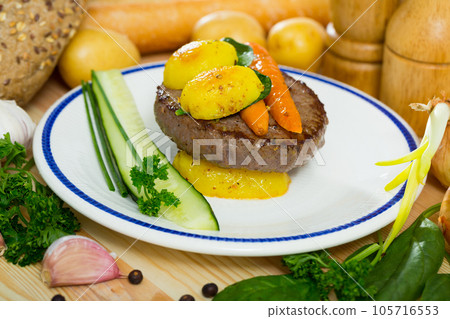 Beef cutlet with baked new potatoes and carrots Beef cutlet with baked new potatoes and carrots 105716553