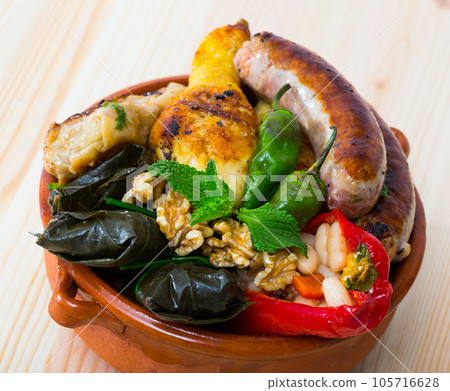 Kapama a dish of bulgarian cuisine with assortiment meat, grape rolls 105716628