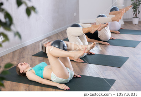 Girl participates in group lesson with sof tball, modern sport in studio. 105716833