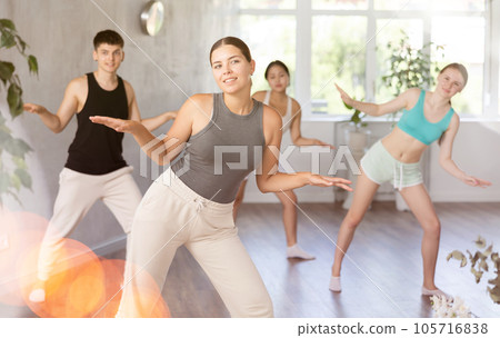 Young woman training dance positions during workout session 105716838