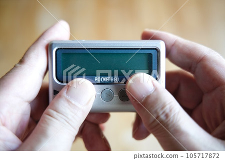 pager held in both hands pager held in both hands 105717872