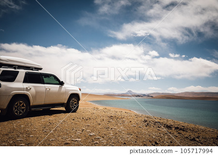 Driving off road car on the high altitude mountains Driving off road car on the high altitude mountains 105717994