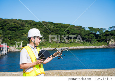 Male worker preparing a drone for inspection | Drone inspection image Male worker preparing a drone for inspection | Drone inspection image 105718107