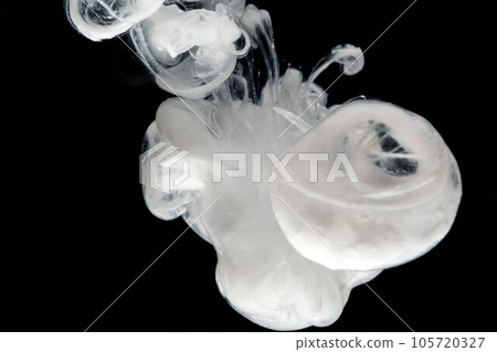 Abstract paint splash isolated on black background. Acrylic ink in water. selective focus. 105720327