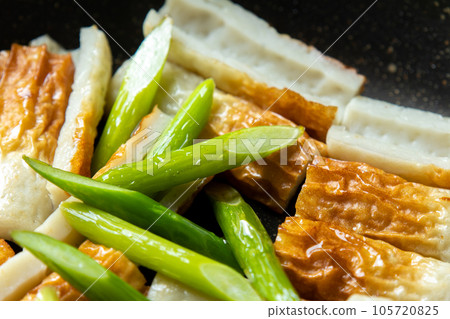 Stir-fried chikuwa and garlic sprouts, cooking scene. Stir-fried chikuwa and garlic sprouts, cooking scene. 105720825