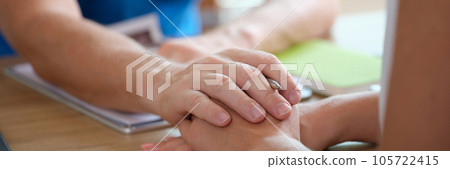 Doctor puts his hand on hand of patient, explaining dangerous diagnosis. Doctor puts his hand on hand of patient, explaining dangerous diagnosis. 105722415