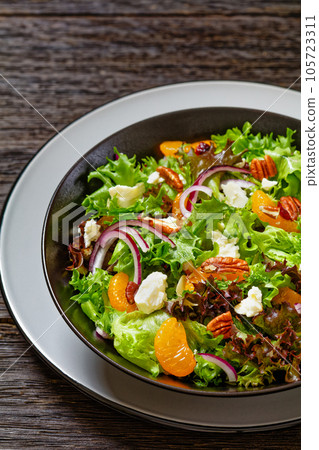 Mandarin Orange Salad in black bowl, top view Mandarin Orange Salad in black bowl, top view 105723311