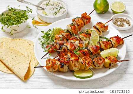 chicken souvlaki with thyme and lime on plate 105723315