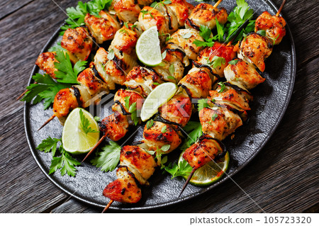 chicken souvlaki with parsley and lime on plate chicken souvlaki with parsley and lime on plate 105723320