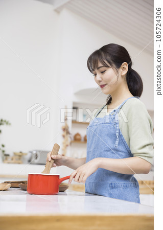年輕的家庭主婦在廚房做飯 烹飪圖像 年輕的家庭主婦在廚房做飯 烹飪圖像 105724306