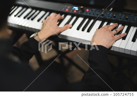 close-up of a pianist's hands while playing the piano 105724755