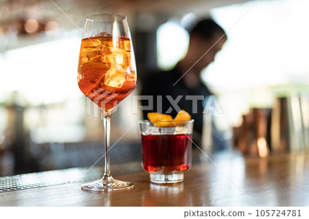 the bartender prepares a beautiful alcoholic cocktail at the bar counter 105724781