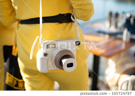 a modern fashionable film camera that takes instant photos a modern fashionable film camera that takes instant photos 105724787