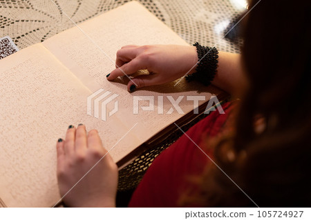 close-up of a woman's hand reading a braille book close-up of a woman's hand reading a braille book 105724927