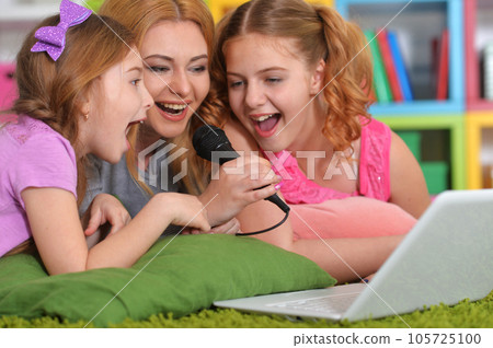 woman and girls using laptop woman and girls using laptop 105725100