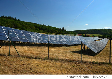Solar power plant - concept for electricity and ecological industry. High energy prices. Beautiful landscape and sunny day with blue sky. Photovoltaic power plant. 105725759
