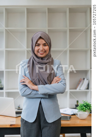 Portrait of confident muslim businesswoman in hijab standing workplace in office 105727205