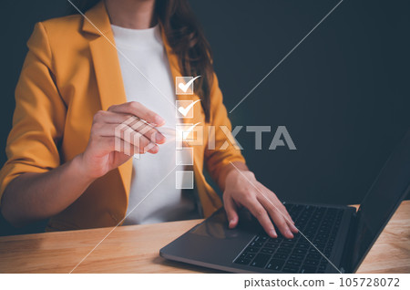 Businesswoman using laptop online checklist survey, filling out digital form checklist, take an assessment, questionnaire, evaluation, online survey, online exam, Business performance checklist. Businesswoman using laptop online checklist survey, filling out digital form checklist, take an assessment, questionnaire, evaluation, online survey, online exam, Business performance checklist. 105728072