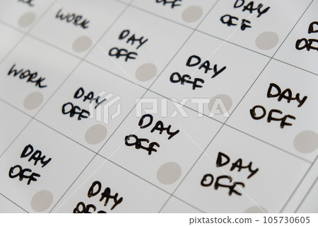 Magnetic board writing 4 day work week calendar with three weekend days off four day working week concept. Modern approach doing business short workweek. Effectiveness of employees. Productivity and 105730605