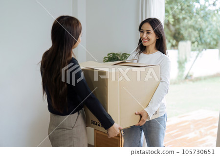 Young woman couple smiling happy and moving box together at new home. Homosexual-LGBTQ concept Young woman couple smiling happy and moving box together at new home. Homosexual-LGBTQ concept 105730651