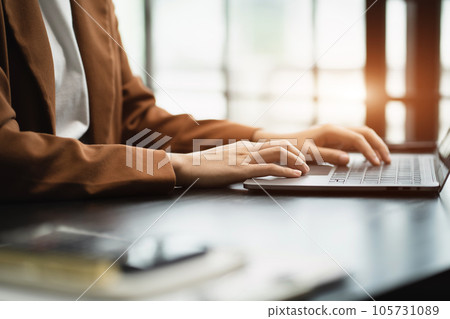 Businessman using laptop computer in office. Happy man, entrepreneur, small business owner working online 105731089