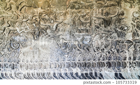 Wall carving of Khmer Culture in Ancient ruins Angkor Wat temple - famous Cambodian landmark. Siem Reap, Cambodia. Wall carving of Khmer Culture in Ancient ruins Angkor Wat temple - famous Cambodian landmark. Siem Reap, Cambodia. 105733319